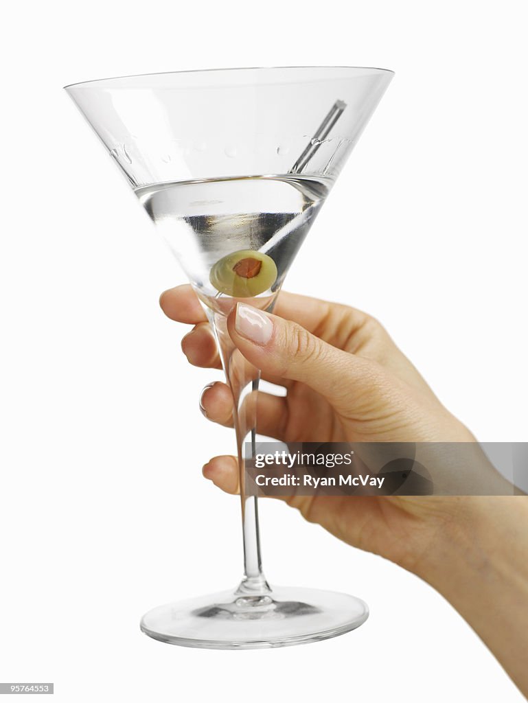 Woman's hand holding a martini glass