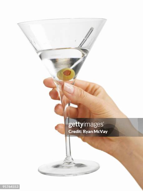 woman's hand holding a martini glass - martini stock pictures, royalty-free photos & images