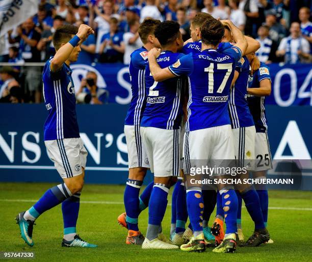 Schalke's players celebrate after scoring the 1-0during the German first division Bundesliga football match FC Schalke 04 vs Eintracht Frankfurt in...