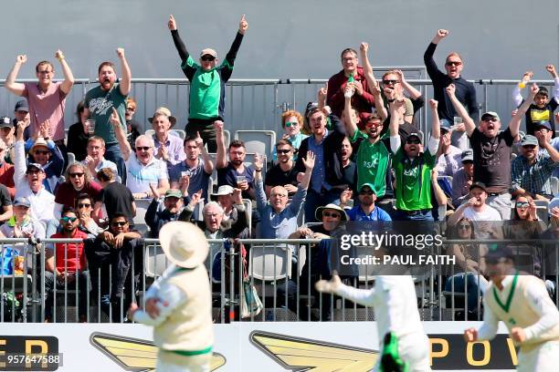 Ireland fans in the crowd celebrate the fall of Pakistan's fourth wicket, that of Pakistan's Babar Azam, in the first innings during play on day two...