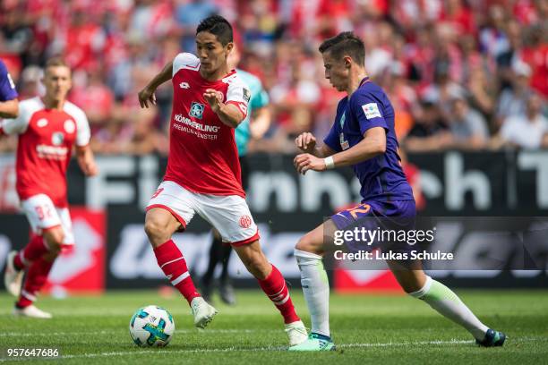 Yoshinori Muto of Mainz and Marco Friedl of Bremen in action during the Bundesliga match between 1. FSV Mainz 05 and SV Werder Bremen at Opel Arena...