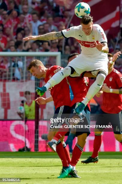 Stuttgart's German forward Daniel Ginczek and Bayern Munich's German striker Thomas Mueller vie for the ball during the German first division...