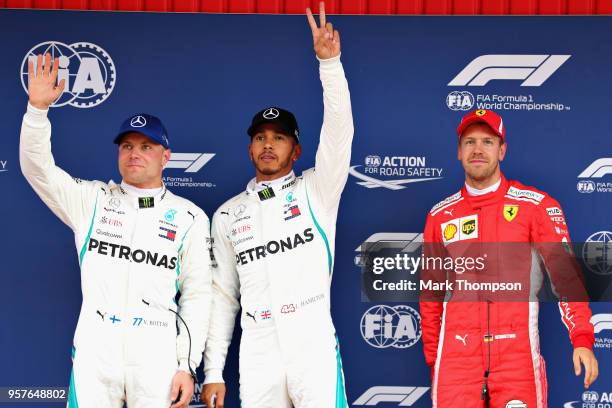 Top three qualifiers Lewis Hamilton of Great Britain and Mercedes GP, Valtteri Bottas of Finland and Mercedes GP and Sebastian Vettel of Germany and...