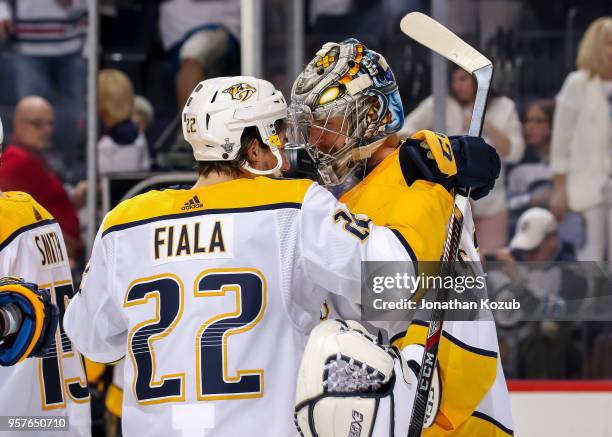 Kevin Fiala of the Nashville Predators congratulates goaltender Pekka Rinne following a 4-0 shutout over the Winnipeg Jets in Game Six of the Western...