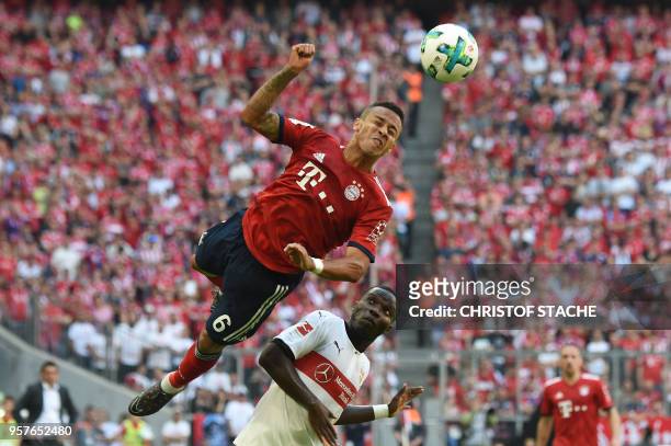 Bayern's Spanish midfielder Thiago Alcantara heads the ball next to Stuttgart's Orel Mangala during the German first division Bundesliga football...