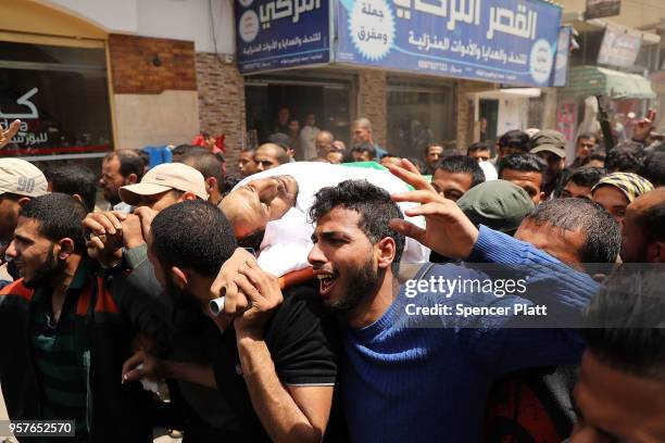 The body of Jabir Abu Mustafa is brought through the streets of Khan Yunis during his funeral on May 12, 2018 in Khan Yunis, Gaza. Mustafa , who had...