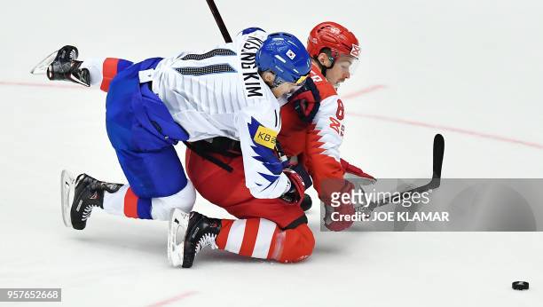 South Korea's Kim Kisung challenges for the puck with Denmark's Mikkel Boedker during the group B match Denmark vs Korea of the 2018 IIHF Ice Hockey...
