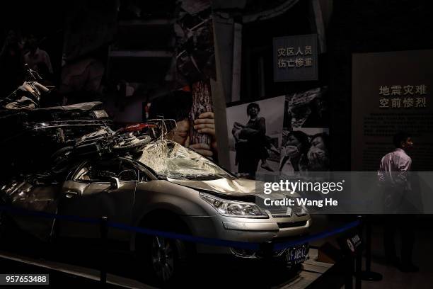 Visitors attend the Wenchuan Earthquake Memorial Museum at the ruins of earthquake-hit Beichuan county during the ten year anniversary on May 12,...