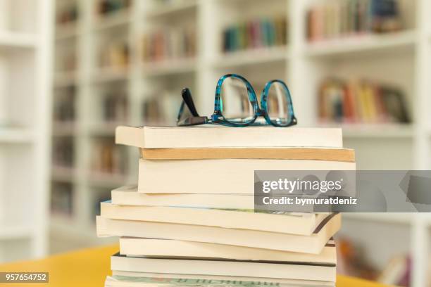 glasses and book at library - reading glasses on table stock pictures, royalty-free photos & images