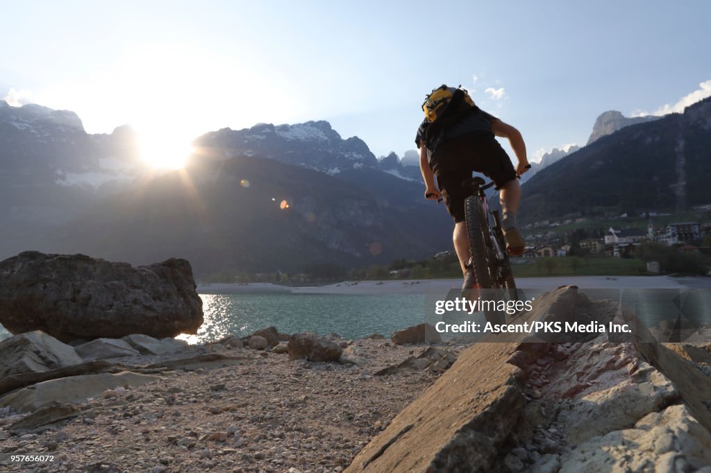Mountain biker creates own trail at lake edge