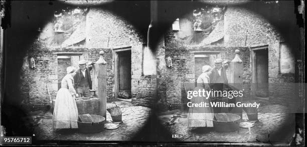 Domestic servant washing fish at the pump, circa 1857. From William Grundy's 'English Views'.