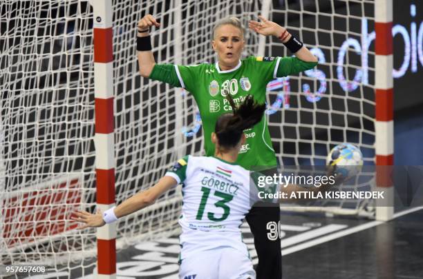 Captain Anita Görbicz of Hungarian Gyor Audi ETO scores a goal against goalkeeper Paula Claudia Ungureanu of Romanian CSM Bucuresti during their...