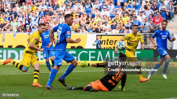 Adam Szalai of Hoffenheim scores the second goal for his team against Roman Buerki of Dortmund during the Bundesliga match between TSG 1899...