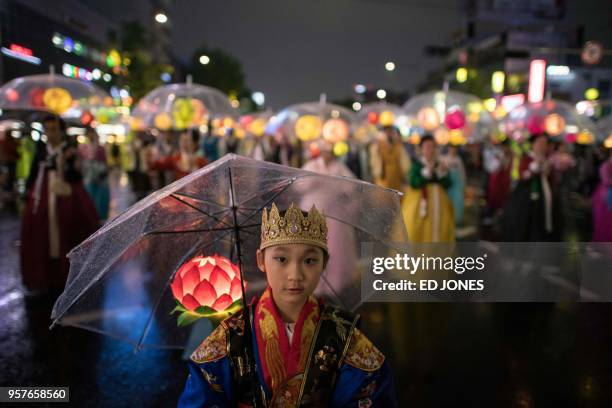 Participants march during a lantern parade as part of a 'Lotus Lantern Festival' to celebrate the upcoming Buddha's birthday, in Seoul on May 12,...