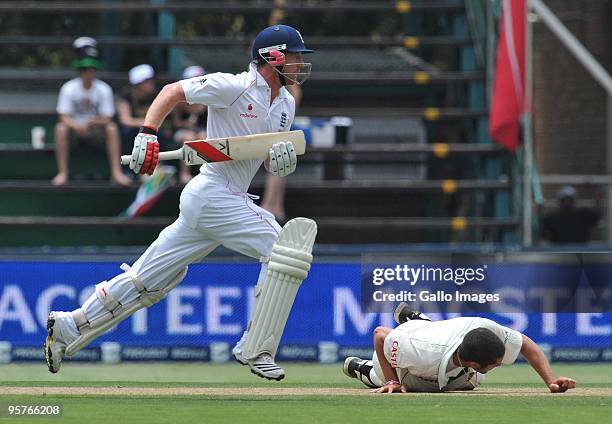 Paul Collingwood of England runs a single with bowler Wayne Parnell of South Africa on the deck during day one of the fourth test match between South...