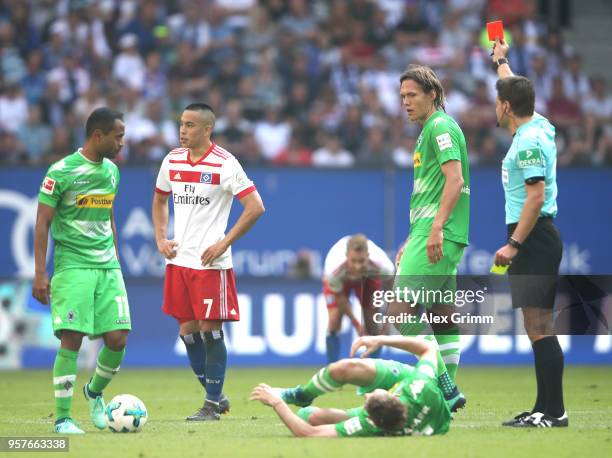 Bobby Wood of Hamburger SV is shown a red card by referee Felix Brych after recieving a second yellow during the Bundesliga match between Hamburger...