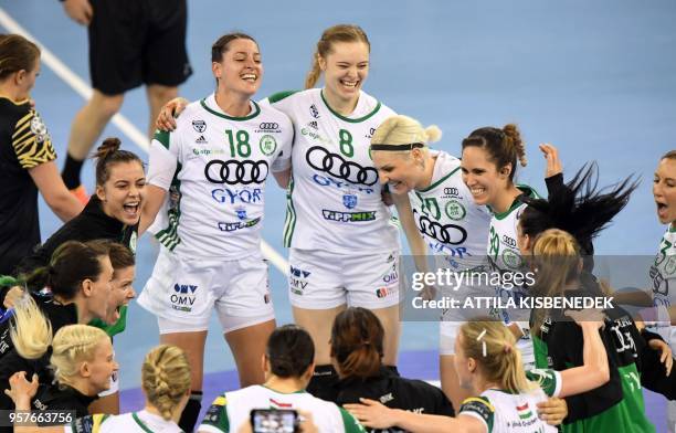 Hungarian Gyor Audi ETO's players celebrate their victory over Romanian CSM Bucuresti at the end of their handball semi-final match of the EHF...