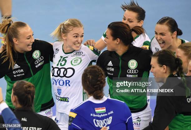 Hungarian Gyor Audi ETO's players celebrate their victory over Romanian CSM Bucuresti at the end of their handball semi-final match of the EHF...