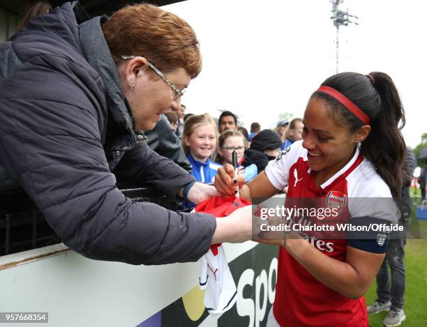 Alex Scott of Arsenal signs a shirt for a fan during the Womens Super League match between Arsenal Ladies and Manchester City Women at Meadow Park on...