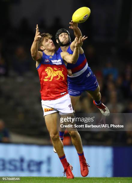Zac Bailey of the Lions and Caleb Daniel of the Bulldogs compete for the ball during the round eight AFL match between the Western Bulldogs and the...