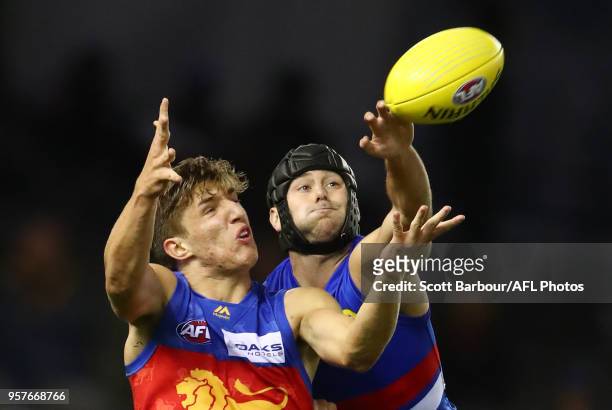 Zac Bailey of the Lions and Caleb Daniel of the Bulldogs compete for the ball during the round eight AFL match between the Western Bulldogs and the...