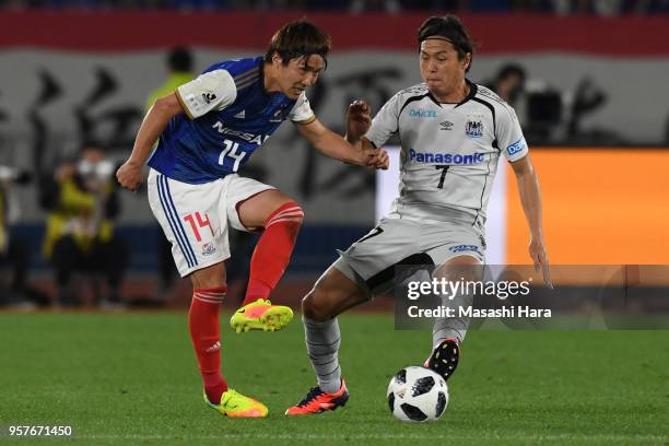 Jun Amano of Yokohama F.Marinos and Yasuhito Endo of Gamba Osaka compete for the ball during the J.League J1 match between Yokohama F.Marinos and...