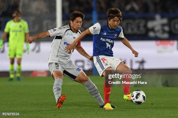 Jun Amano of Yokohama F.Marinos and Genta Miura of Gamba Osaka compete for the ball during the J.League J1 match between Yokohama F.Marinos and Gamba...