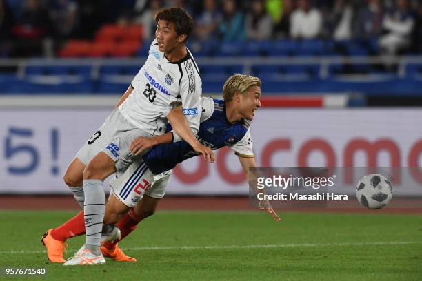 Ryosuke Yamanaka of Yokohama F.Marinos and Shun Nagasawa of Gamba Osaka compete for the ball during the J.League J1 match between Yokohama F.Marinos...