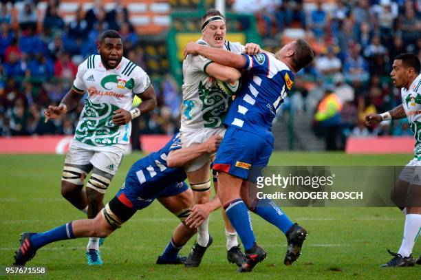 Brodie Retallick , lock of the the Chiefs, from New Zealand, is tackled by Jakobus Janse van Rensburg of the Stormers, from South Africa, during the...