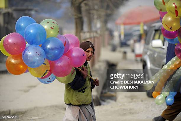 An Afghan boy sells balloons in Kabul on January 14, 2010. The number of civilians killed in the Afghan war jumped last year to 2,412 from the...
