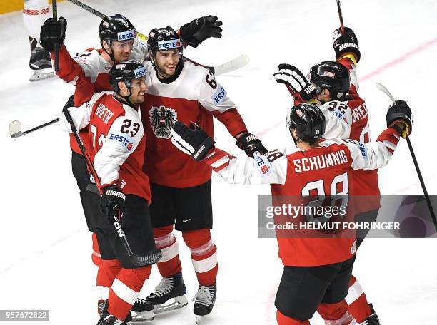 Austrian players Fabio Hofer, Michael Raffl, Konstantin Komarek and teammates celebrate their team's third goal during the group A match Austria vs...