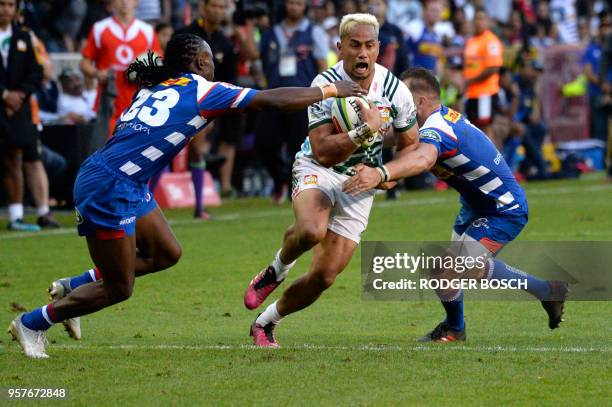 Toni Pulu of the Chiefs, from New Zealand, tries to evade Seabelo Senatla and Dewaldt Duwenage of the Stormers, from South Africa, during the Super...