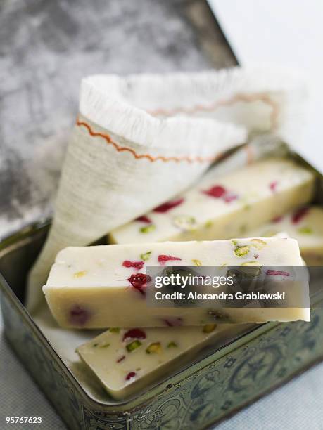 white fudge with dried cranberries and pistachios - white fudge stock pictures, royalty-free photos & images