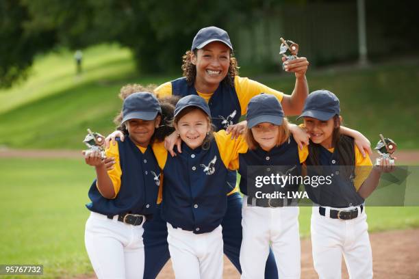 happy little league team holding trophies - title nine imagens e fotografias de stock