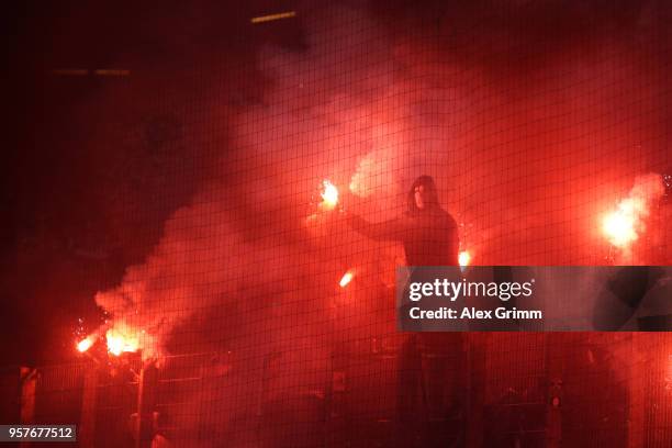 Fans set off flares during the Bundesliga match between Hamburger SV and Borussia Moenchengladbach at Volksparkstadion on May 12, 2018 in Hamburg,...