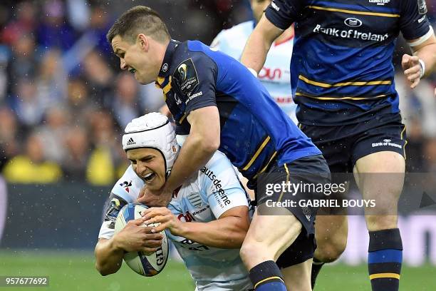 Racing 92's South African fullback Pat Lambie is tackled by Leinster's Irish fly-half Johnny Sexton during the 2018 European Champions Cup final...