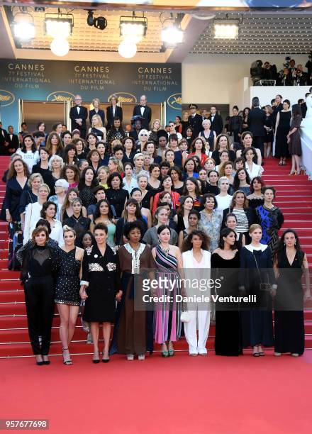 Filmmakers hold hands as Jury head Cate Blanchett with other filmmakers read a statement on the steps of the red carpet in protest of the lack of...