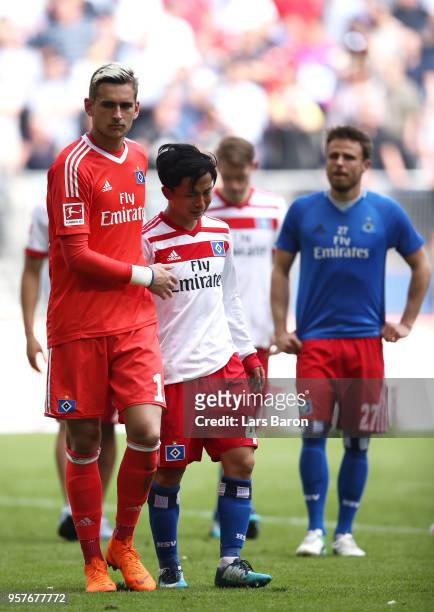 Julian Pollersbeck of Hamburger SV consoles Tatsuya Ito of Hamburger SV as their side are relegated after the Bundesliga match between Hamburger SV...