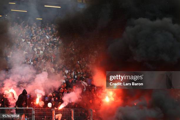 Fans set off flares during the Bundesliga match between Hamburger SV and Borussia Moenchengladbach at Volksparkstadion on May 12, 2018 in Hamburg,...