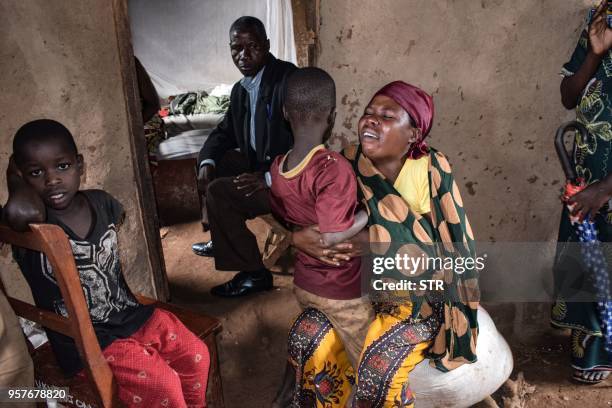 Family members of victims killed by an armed group react at Ruhagarika village where 26 people were killed in northwestern Burundi bordering with the...