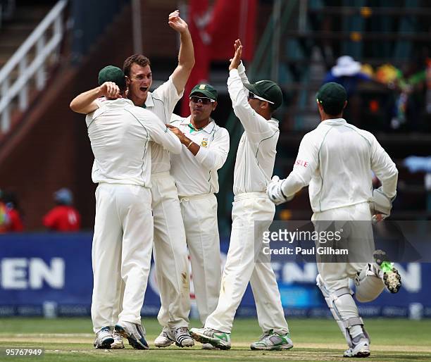 Ryan McLaren of South Africa celebrates with his team-mates after taking the wicket of Paul Collingwood of England for 47 runs when he was caught out...