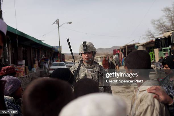 Children speak with a soldier from a Provincial Reconstruction Team on patrol January 14, 2010 in Orgune, Afghanistan. Soldiers, from Forward...