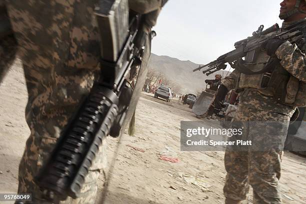 Soldiers from a Provincial Reconstruction Team stand on patrol January 14, 2010 in Orgune, Afghanistan. Soldiers, from Forward Operating Base Orgun-E...