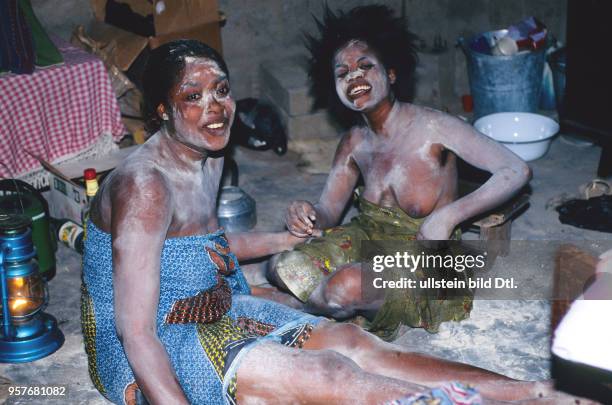 The vodu priestess Wekenou doing a healing ceremony for two girls followed by bad luck. The two unlucky girls waiting for their healing. -