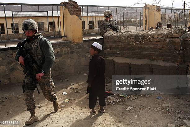 Soldiers from a Provincial Reconstruction Team walk through a market while on patrol January 14, 2010 in Orgune, Afghanistan. Soldiers, from Forward...