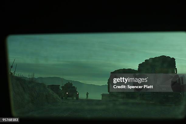 Viewed from inside a military vehicle, a US Army truck makes its way around a bend during a patrol in an area prone to ambushes January 14, 2010 in...