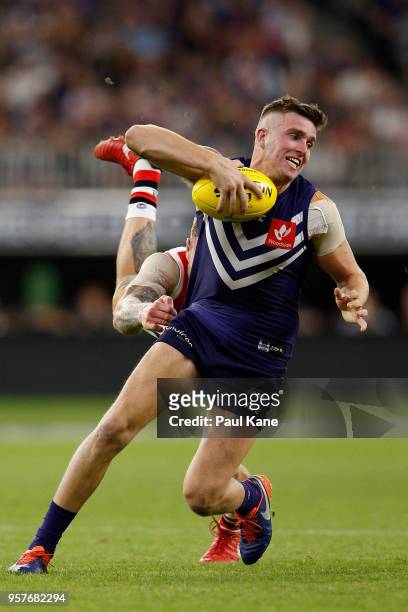Luke Ryan of the Dockers breaks from a tackle by Tim Membrey of the Saints during the round eight AFL match between the Fremantle Dockers and the St...