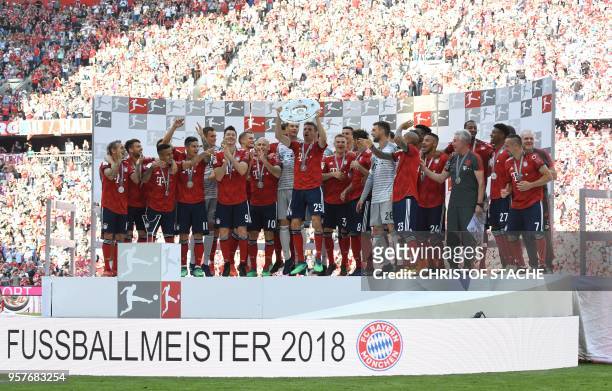 Bayern Munich's German forward Thomas Mueller lifts the trophy during the celebration for the 28th German football championship after the German...