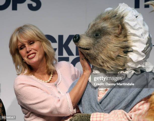 Joanna Lumley and a cast member of Tales of Beatrix Potter attends a photocall for Tickets For Troops at the Royal Opera House on January 11, 2010 in...