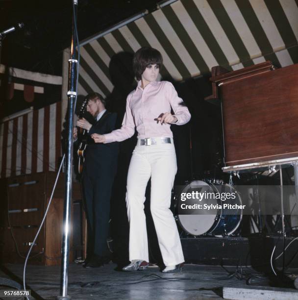 English singer Julie Driscoll performing with Steampacket at the Marquee Club, London, 1965. On the left is guitarist Vic Briggs.